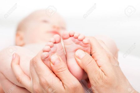 39023272-close-up-shot-of-three-month-baby-girl-receiving-foot-massage-from-a-female-massage-therapist-camera